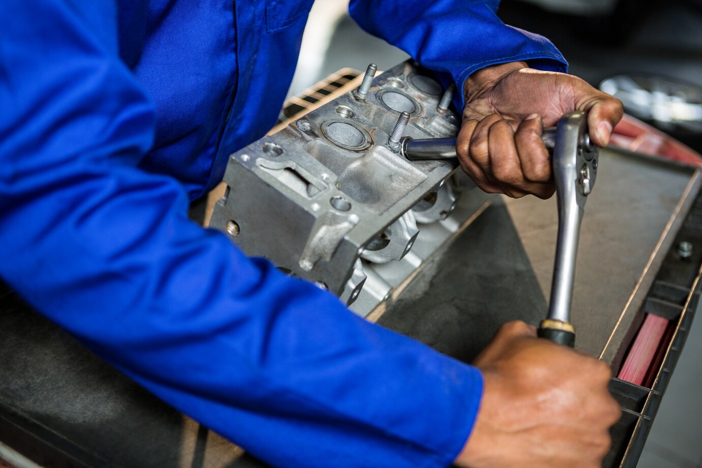 mechanic repairing engine part with ratchet repair garage_1170 1694 1